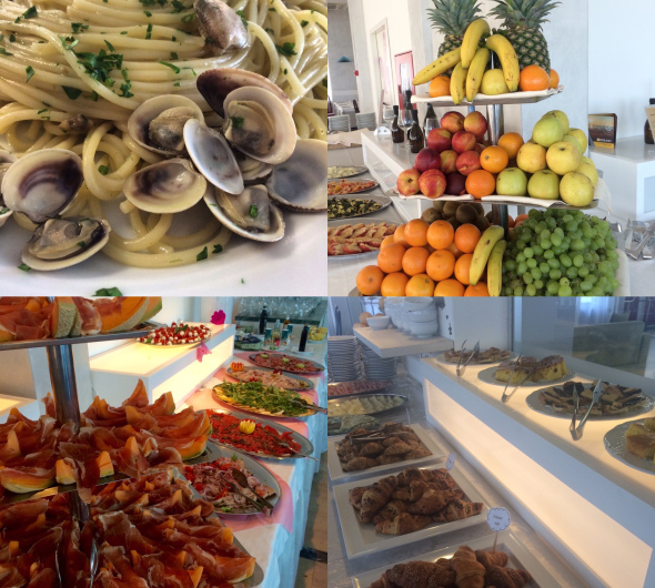 Delizioso buffet con frutta, pasta alle vongole, salumi e dolci.