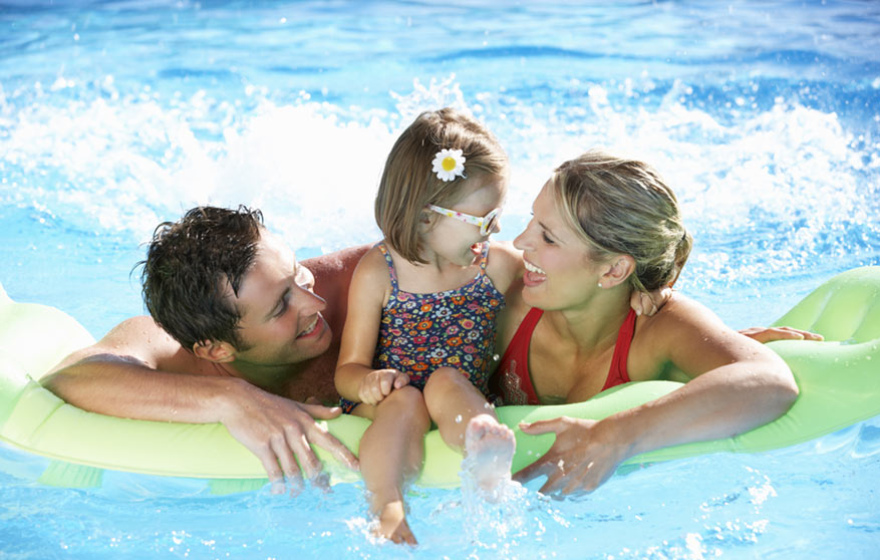 Happy family in the pool on an inflatable float.